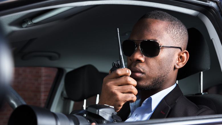 Detective talking on walkie-talkie