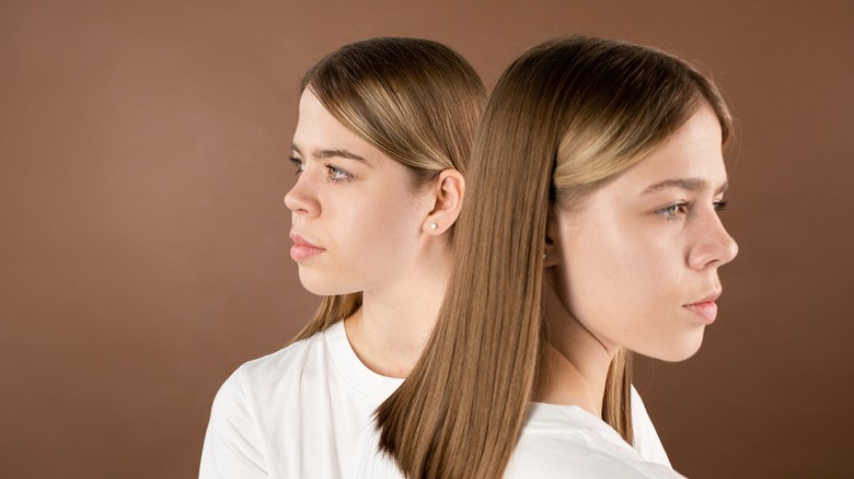 Twin girls looking opposite directions