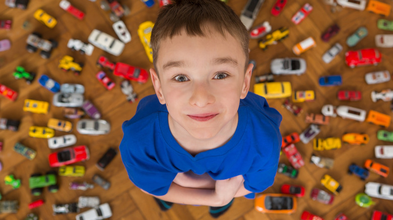 boy with toy car collection