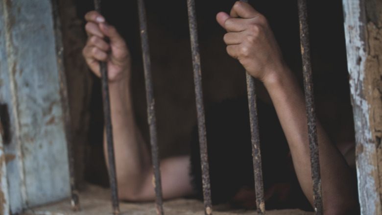 Prisoner behind bars