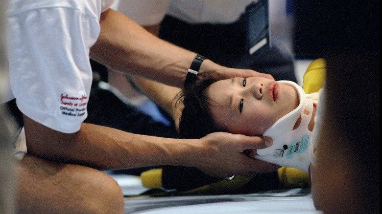 Medics work on Chinese gymnast Sang Lan after her accident
