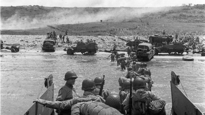 Troops wade ashore from a LCVP landing craft, off Omaha Beach, 6 June 1944