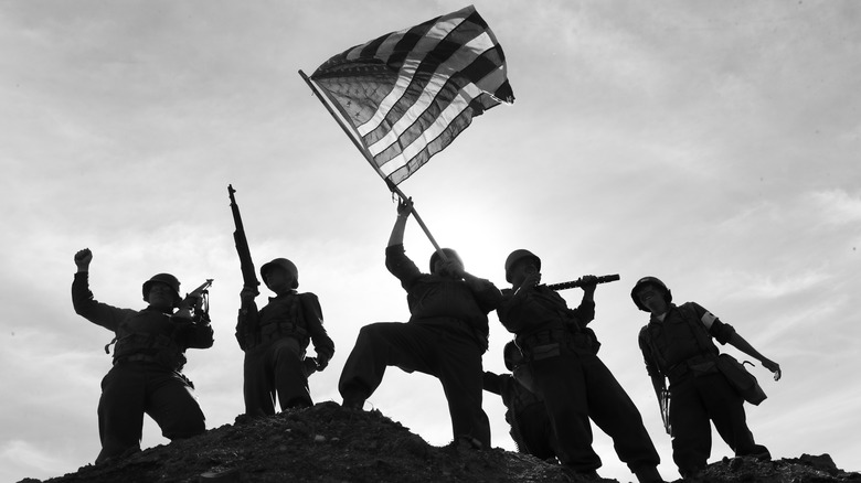 U.S. soldiers lifting American flag