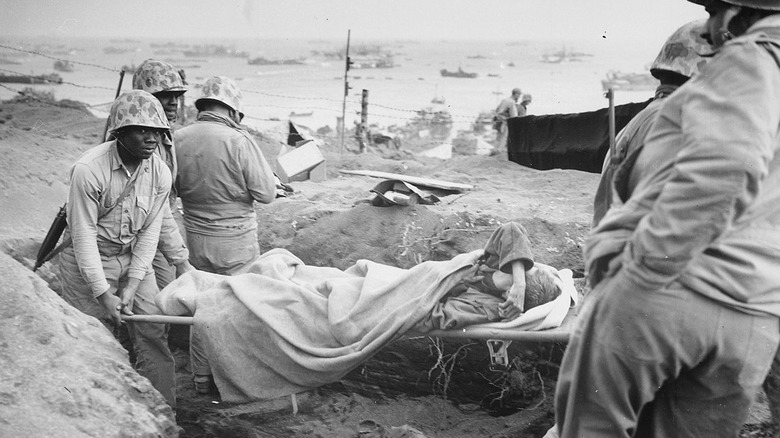U.S. soldiers lifting Japanese man