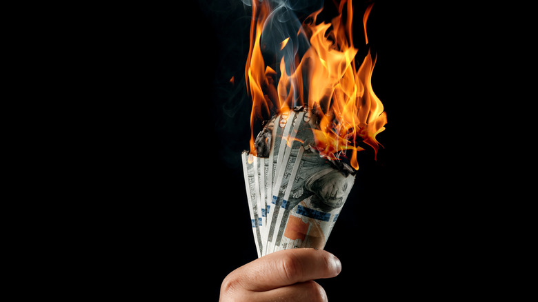 a handful of bills burning
