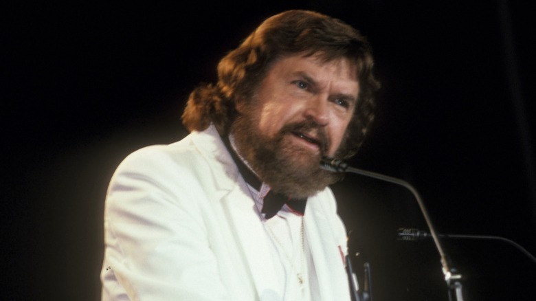 Sam Phillips white suit giving speech onstage