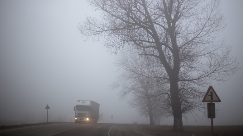 Truck driving through fog