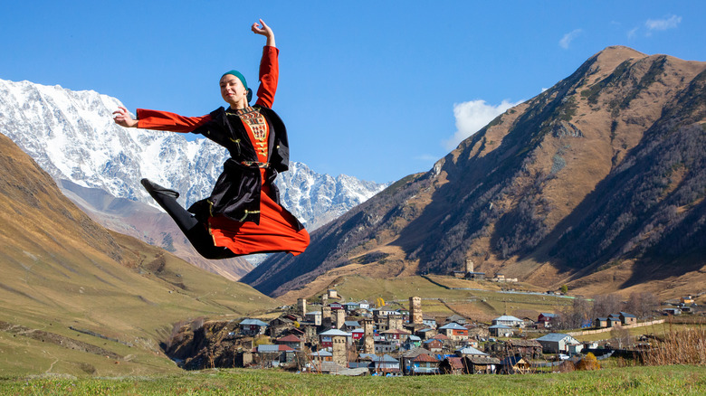 Georgian woman in traditional dress leaping