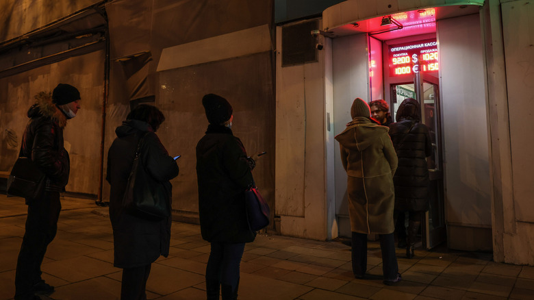 Customers at Russian currency exchange kiosk