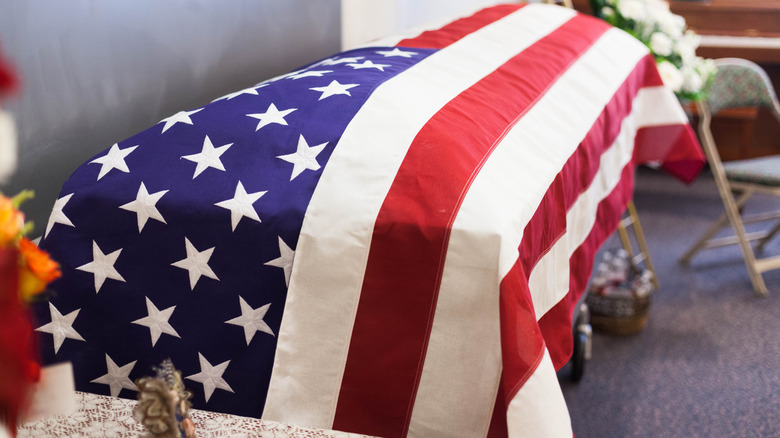 a coffin with an american flag draped on it