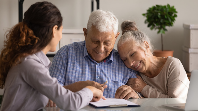 an older couple signing documentation