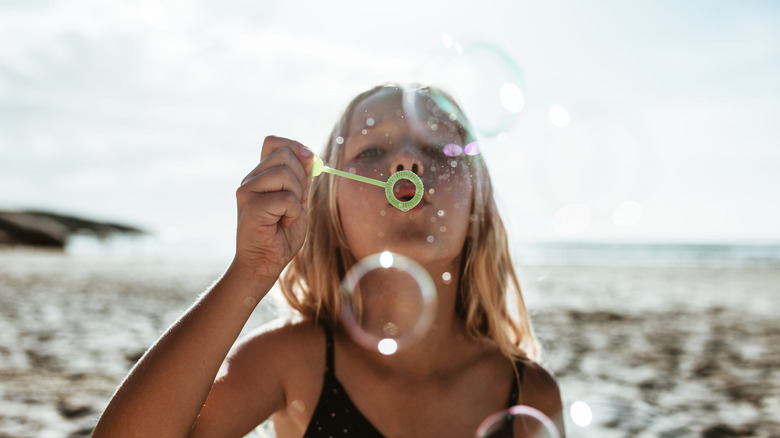 girl blowing bubbles