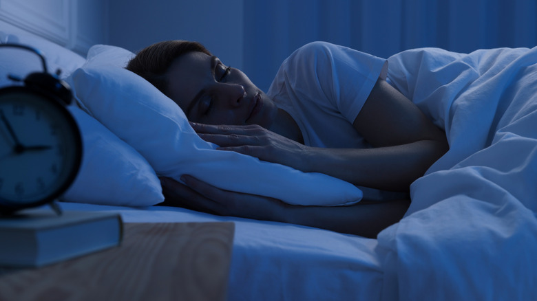 Person asleep in bed at night