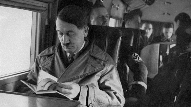 Hitler reading book on airplane