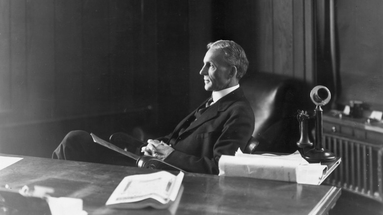 Henry Ford sitting at desk, 1913