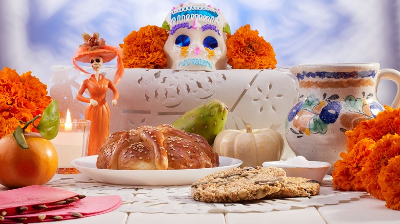 Sugar skulls with Candle, Cempasuchil flowers or Marigold and Papel Picado