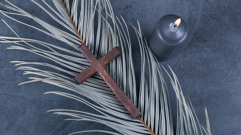 Cross, candle, and palm