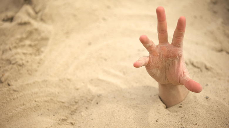 Person sunk into quicksand