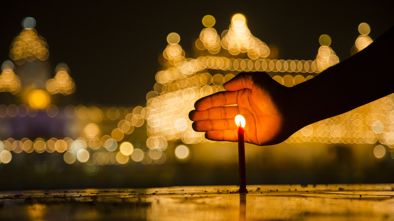 Sikh protecting candle at Golden Temple