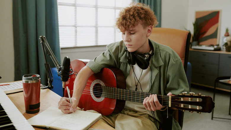 Young man studying guitar