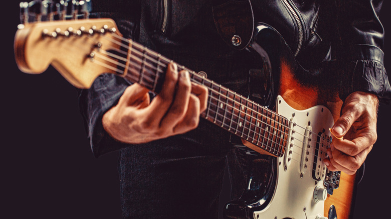 Older person playing Fender Stratocaster