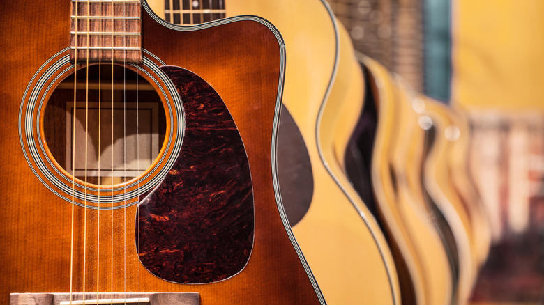 Rack of hanging acoustic guitars