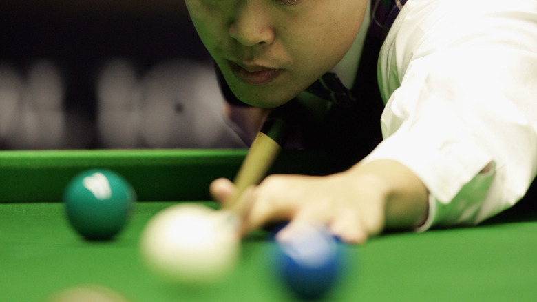 a man playing a cue sport