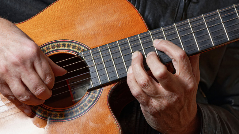 Older gentleman playing acoustic guitar