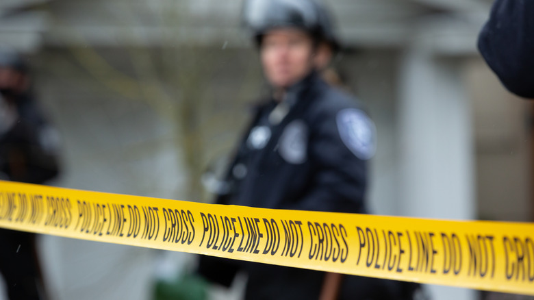 blurry policeman caution tape