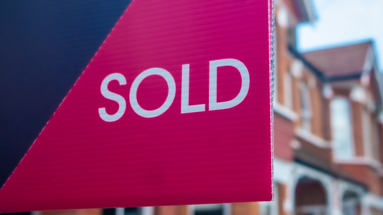 A realtor's sign marks a sale.