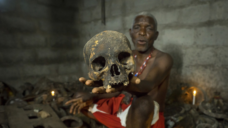 vodou practitioner holding a skull