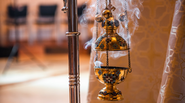 Ornate censer fuming with incense