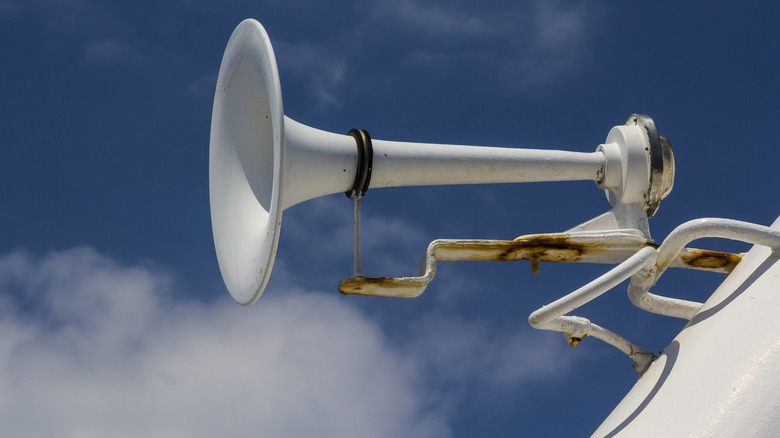 Close up of a fog horn against a blue sky