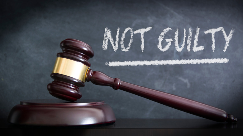 Gavel and not guilty written in chalk