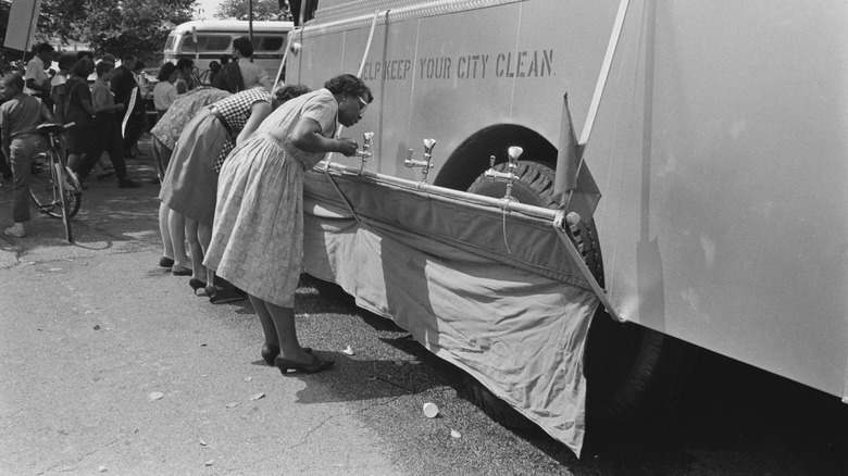 Women drinking water from truck