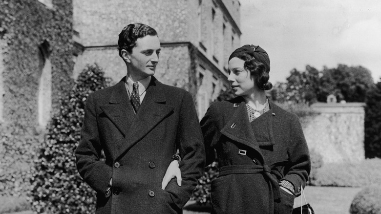 Millionaire Edward James and his wife Lilly Tosch walking outside