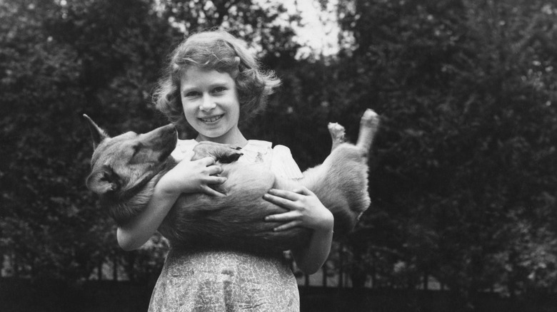 Princess Elizabeth holding a corgi 