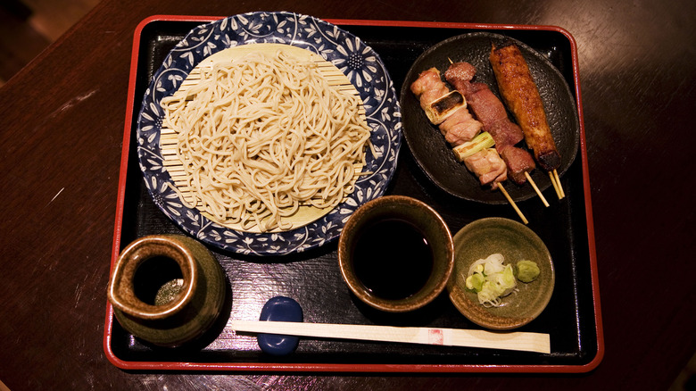 cold soba noodles accompanied by three skewer