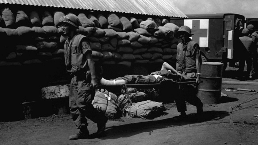 Air Force medics move a Marine casualty to a plane