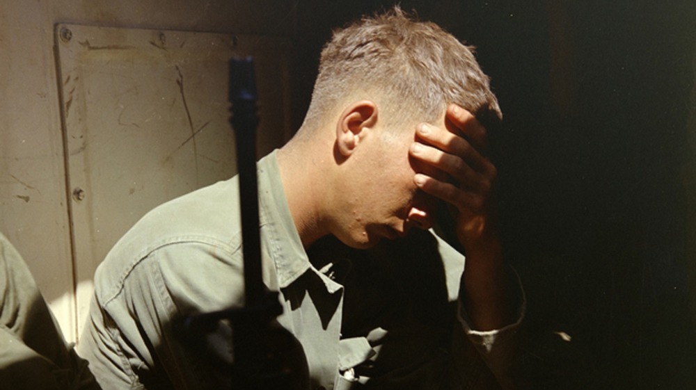 Soldier in Vietnam resting inside an armored personnel carrier