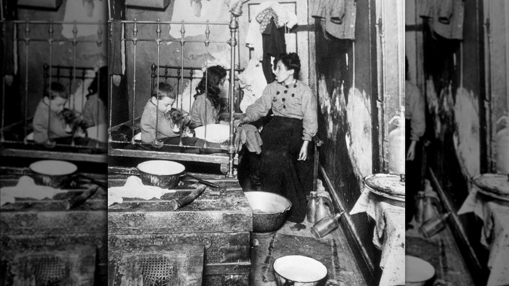 A mother and her two children in their run-down house