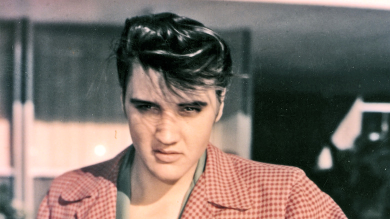 Young Elvis in a red checked blazer