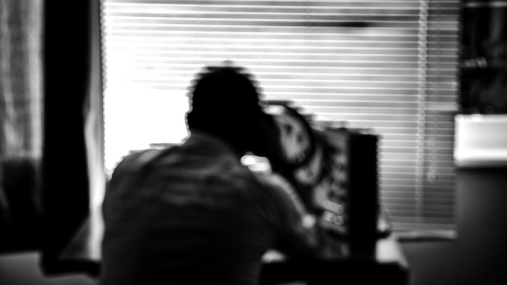 Blurred photo in soft focus of agent listing to wire tap