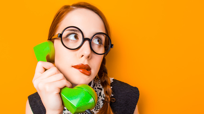 teen in glasses on landline