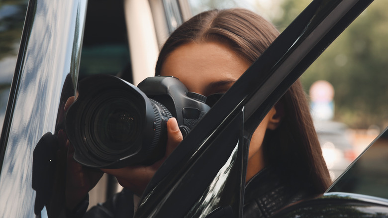 private investigator spying behind car door