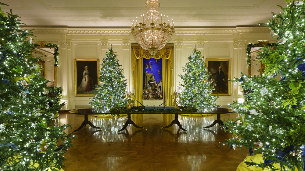 Christmas decorations are displayed in the East Room of the White House