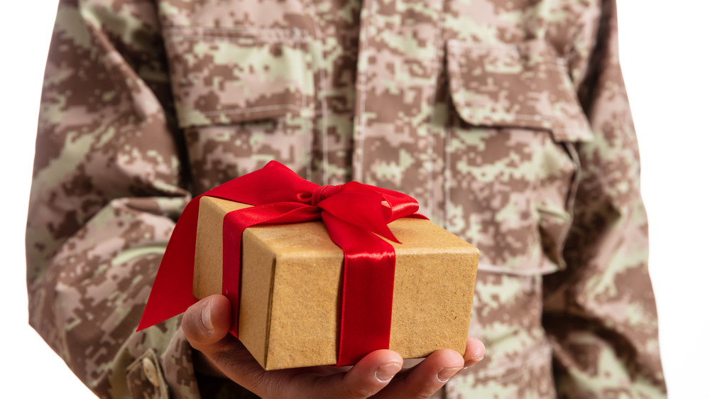 Army soldier holding a Christmas gift