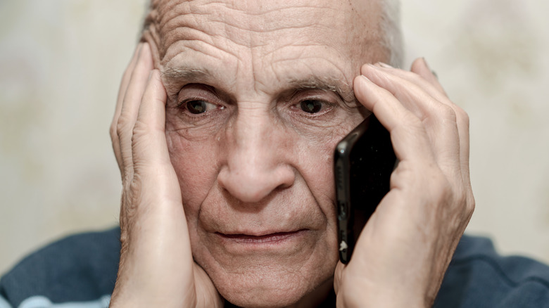 Lonely old man calling on phone