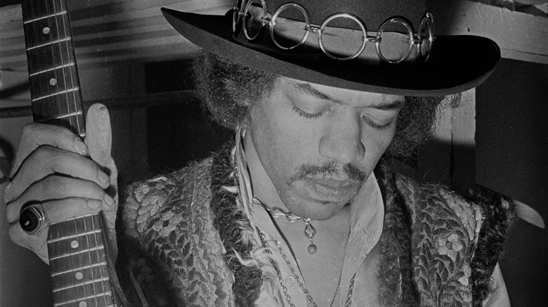 Jimi Hendrix holding a guitar