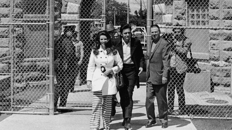 Johnny Cash and June Carter leaving a prison